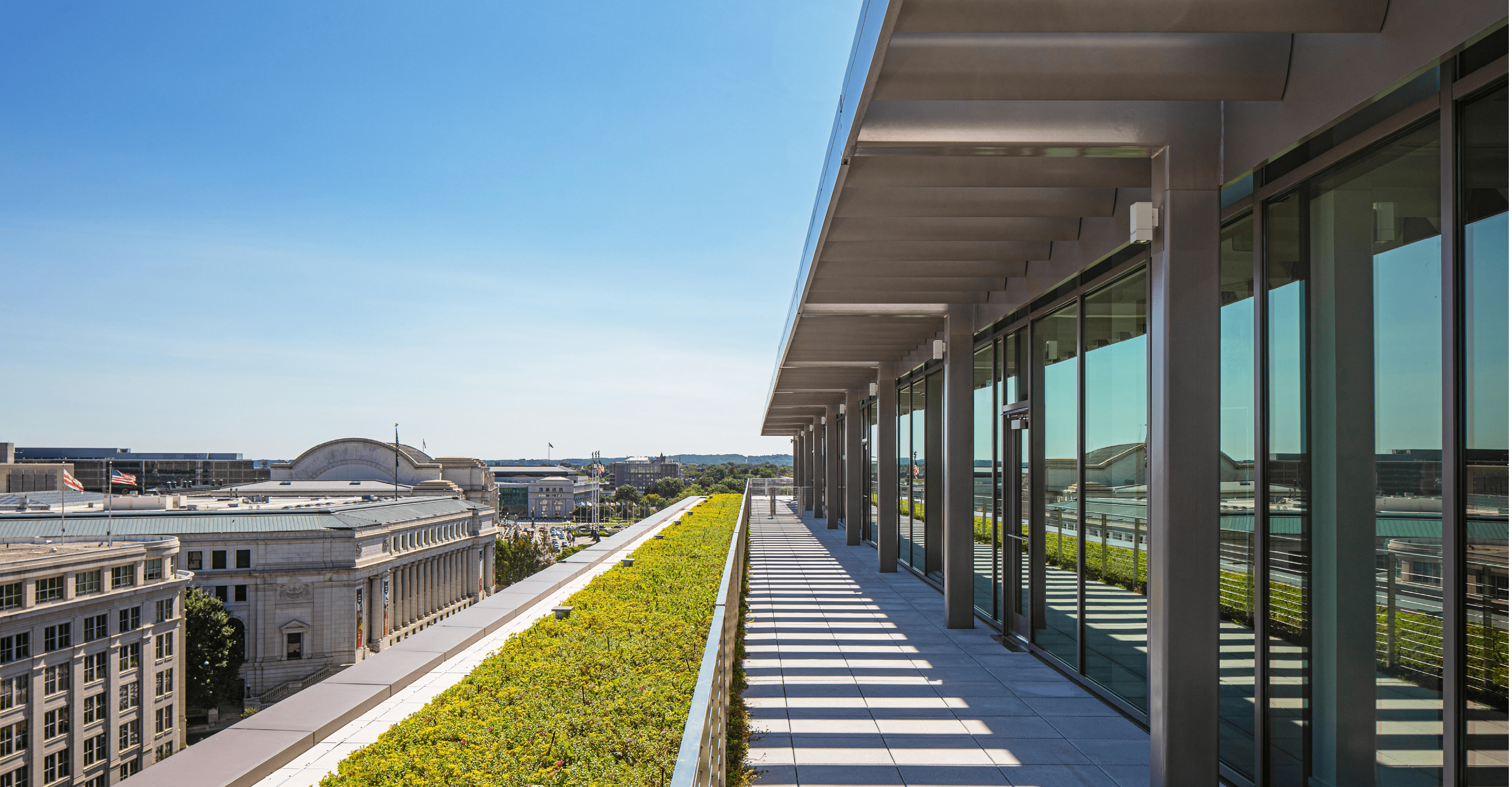 Outdoor walkway with greenery on one of the top floors of 20 Massachusetts Avenue in Washington D.C. The building is owned by OPI and is LEED Gold and WELL Certified.