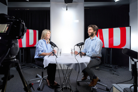 Podcast interview scenario with two people one woman and one man