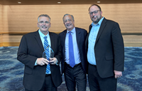 Everforth ECSers Deron Baker (left) and Vic Bogar (right) pose with David Steiner, USPS Postmaster General (center), with award.