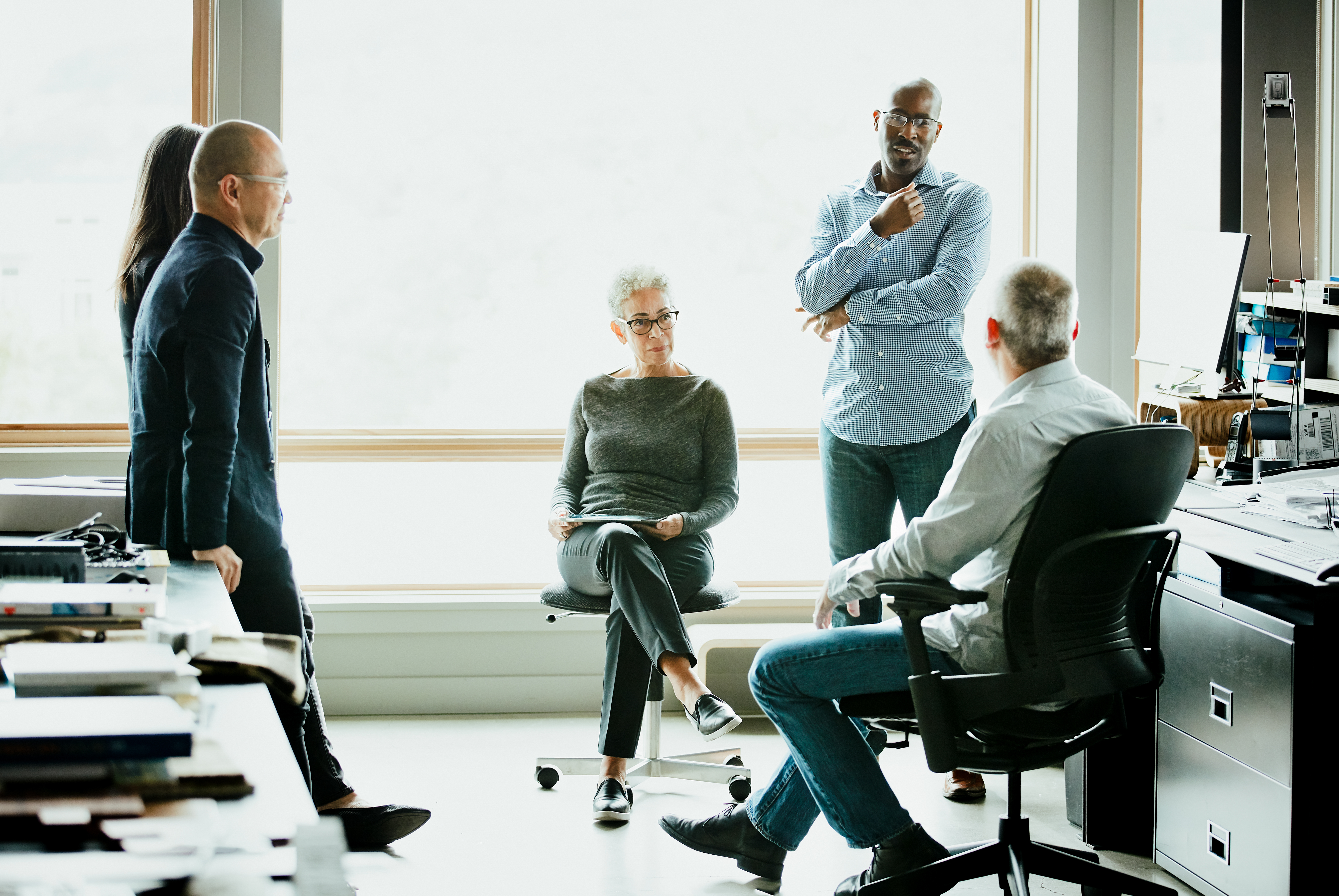Group of people talking in office setting